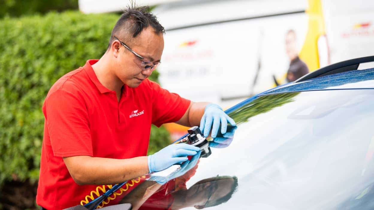 Technician at Autoglass® carrying out a windscreen repair